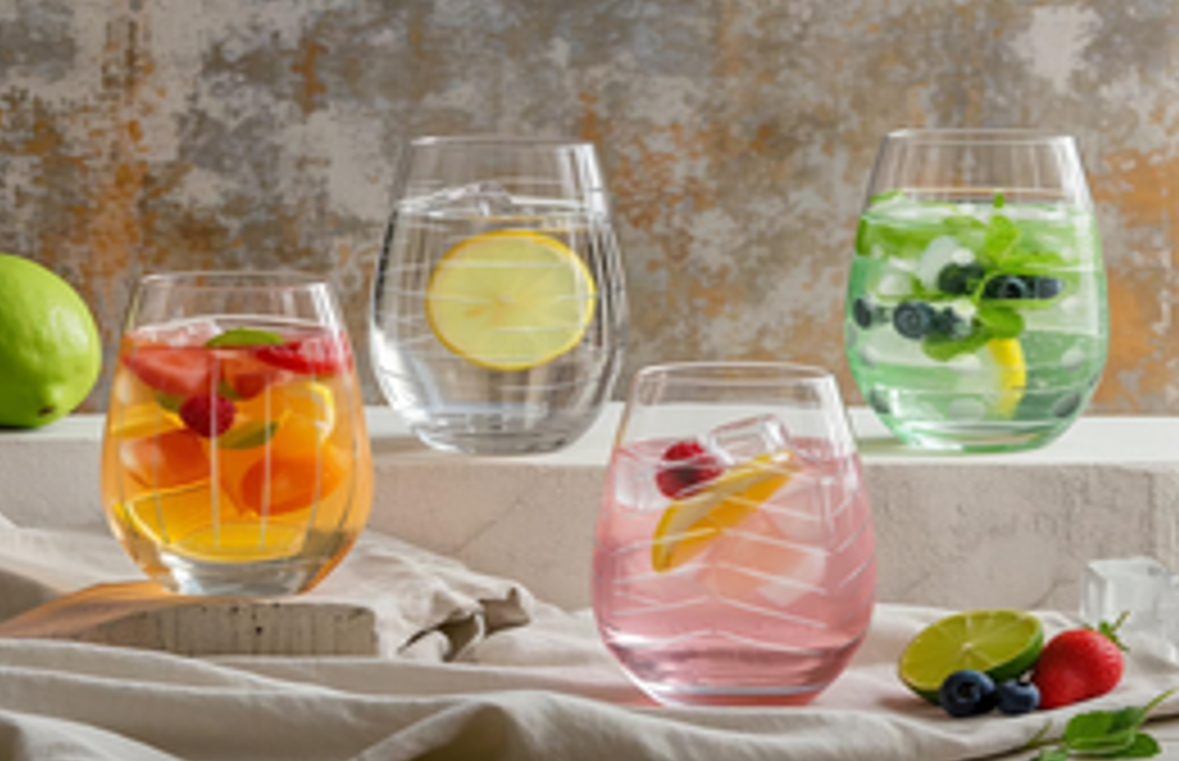 Example of a customer gift: four stemless glasses filled with fruit-garnished drinks, surrounded by fresh fruit. Example of a customer gift: four stemless glasses filled with fruit-garnished drinks, surrounded by fresh fruit.